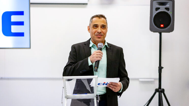 Homem de terno falando em um púlpito com microfone